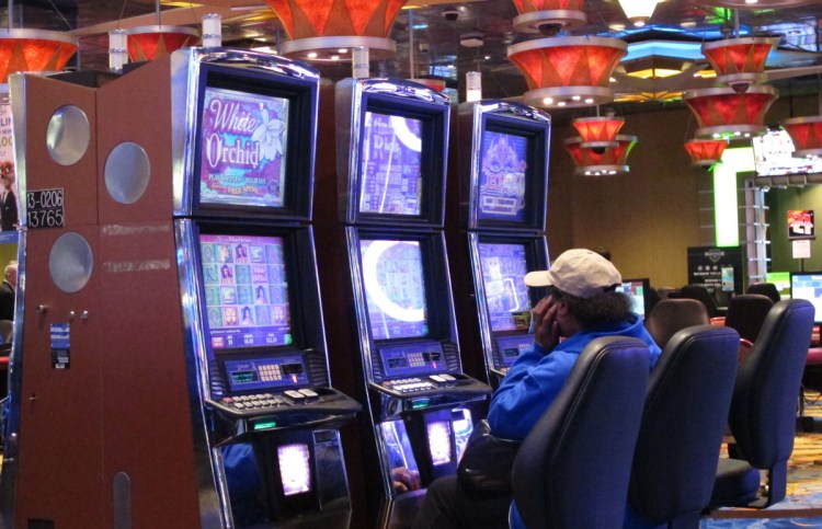 A woman plays a slot machine in Atlantic City, N.J. Organizations that fight gambling addiction say most states are ill-prepared for a wave of problem gamblers likely to be triggered by a recent Supreme Court ruling on sports betting.