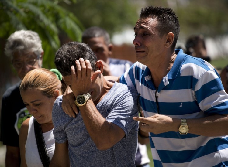 Relatives of passengers who died in Cuba's worst aviation disaster arrive at the morgue, in Havana on Saturday. Doctors say the three survivors are in grave condition.