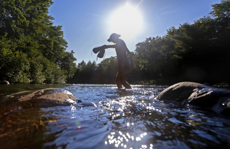 A hiker crosses a stream in 2014 at Gulf Hagas, along the Appalachian Trail Corridor. CMP's proposed transmission line would harm natural resources but provide little benefit to Mainers, a reader writes.
