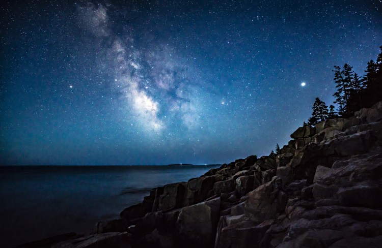 The Milky Way glimmers above the ocean off the coast of Acadia National Park early on the morning of April 23. 