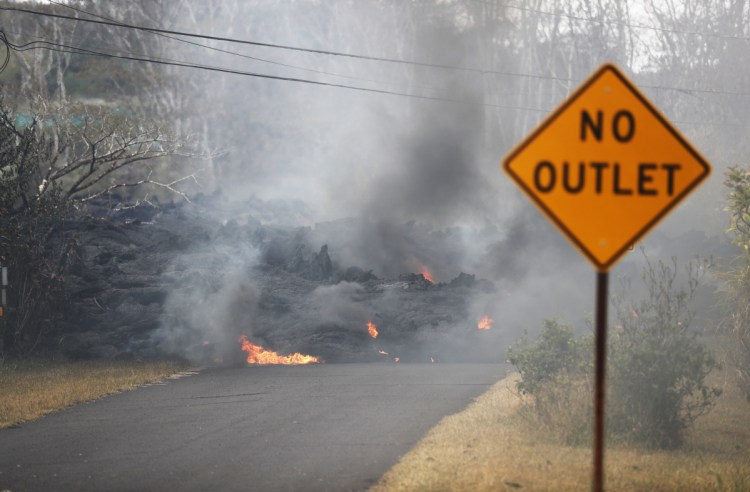 Lava crosses the road on Friday near Pahoa, Hawaii. 