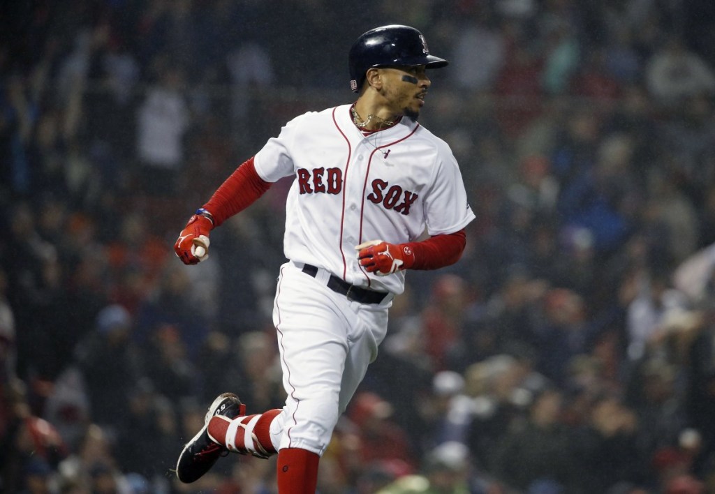 Mookie Betts watches his two-run home run during the fifth inning of Boston's win over the Baltimore Orioles in Boston on Saturday.