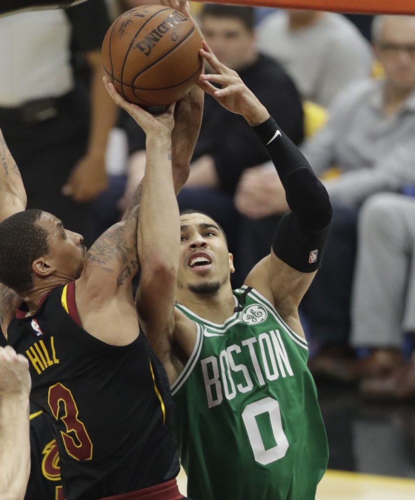 Jayson Tatum of the Celtics drives against George Hill of the Cavaliers during Cleveland's 116-86 win Saturday night in Game 3.