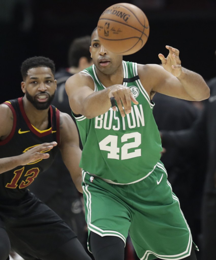 Boston Celtics' Al Horford (42) passes as Cleveland Cavaliers' Tristan Thompson (13) defends in the first half of Game 3 of the NBA basketball Eastern Conference finals, Saturday, May 19, 2018, in Cleveland. (AP Photo/Tony Dejak)