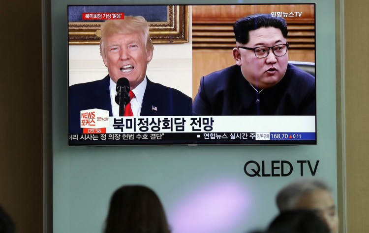 People watch a TV screen showing file footage of U.S. President Trump and North Korean leader Kim Jong Un during a news program at the Seoul Railway Station in Seoul, South Korea. Weeks from his planned North Korea summit, President Trump now says the meeting might not happen.