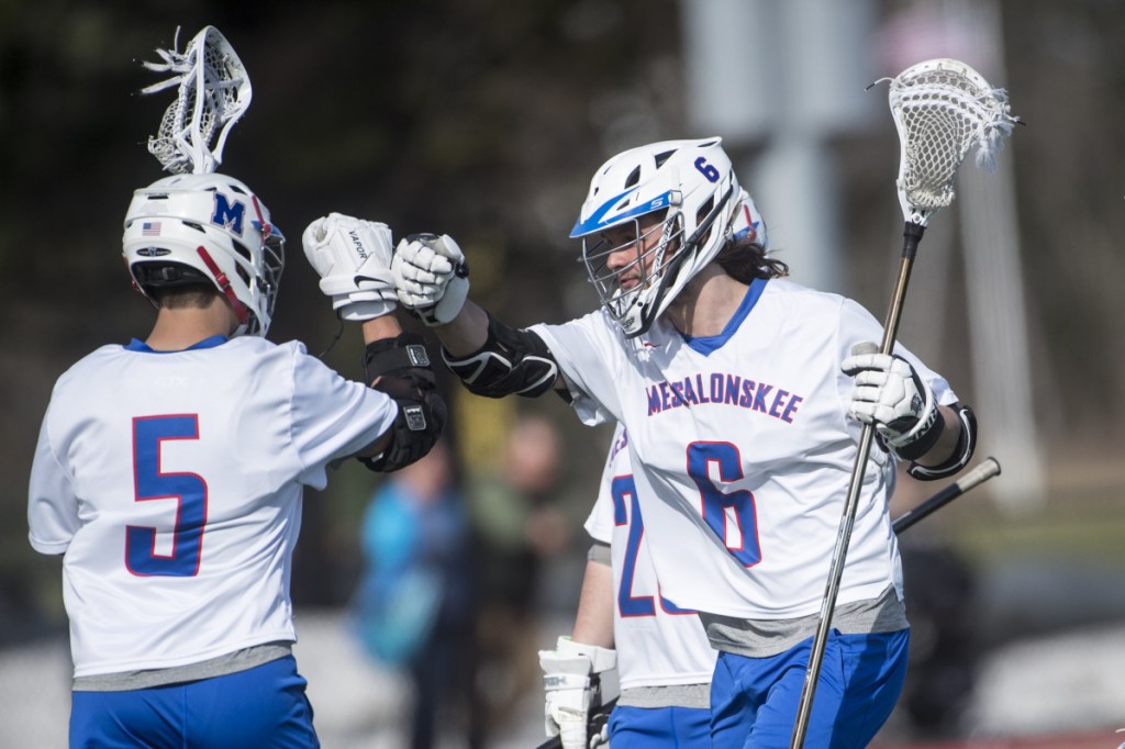 Messalonskee's Matt Trembly (6) center celebrates a goal with teammate Chase Warren (5) in the first half of an April 24 game against Gardiner at Thomas College.