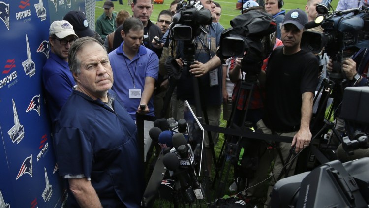 Patriots Coach Bill Belichick holds a press conference on Tuesday during the team's organized team activities. He was his usually chatty self, but had nothing to say about players who did not attend the voluntary session.