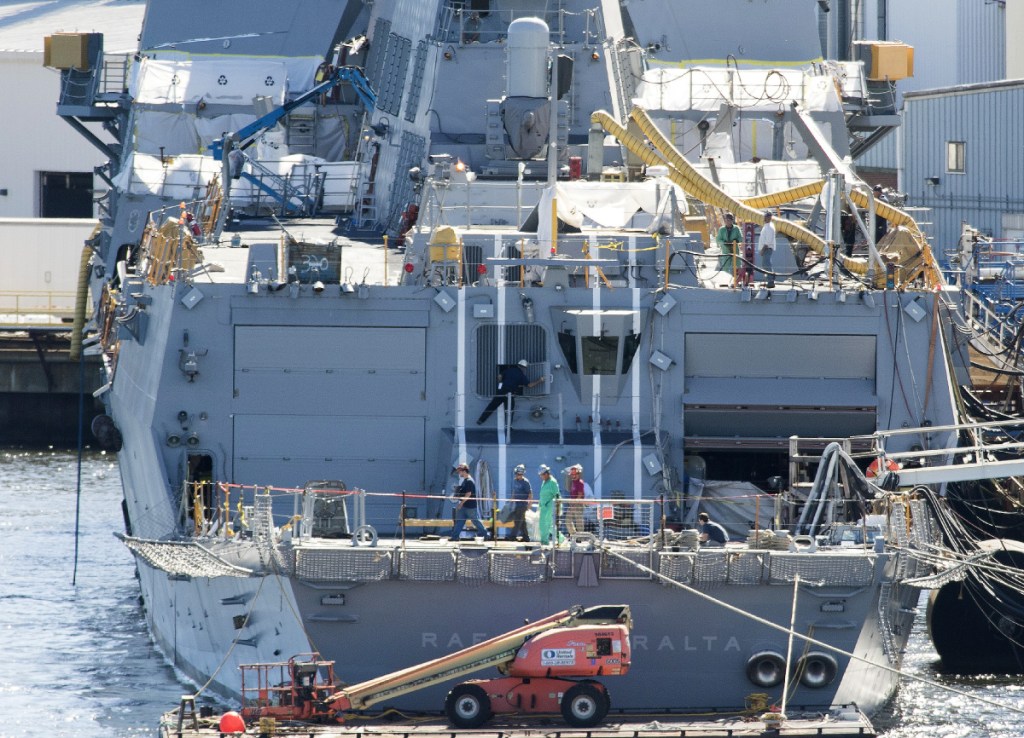 Workers walk across the aft deck of an Arleigh Burke destroyer under construction in 2016 at Bath Iron Works, which is in one of the 32 opportunity zones designated by the governor. The state selected areas with significant assets that could help attract new private investment through "opportunity funding."