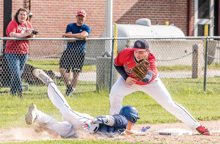 Tim MacDonald of York dives back to third base as Gray-New Gloucester's William Shufelt prepares to apply the tag Wednesday during York's 11-1 win.