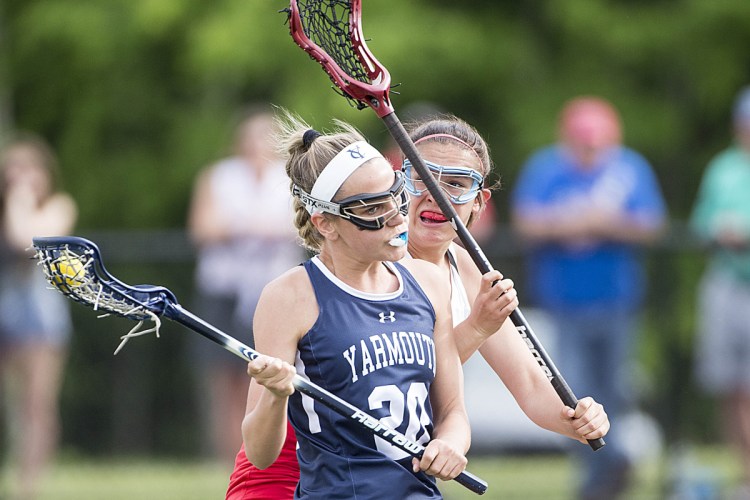 Yarmouth's Greta Elder tries to evade Messalonskee defender Gabby Smart during a Class B lacrosse game Friday afternoon at Thomas College in Waterville. Yarmouth won, 18-7.