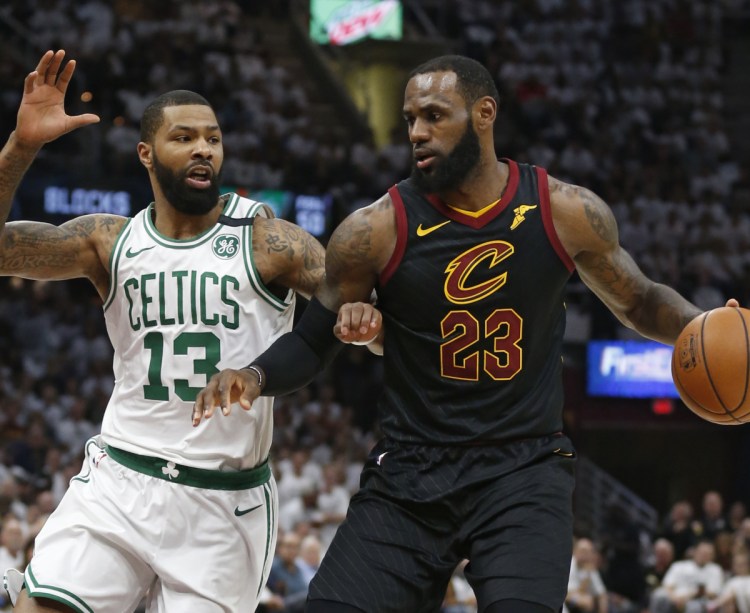 LeBron James, who scored 46 points for Cleveland, tries to drive past Marcus Morris of Boston in the first half of Cleveland's 109-99 victory Friday night to tie their series.