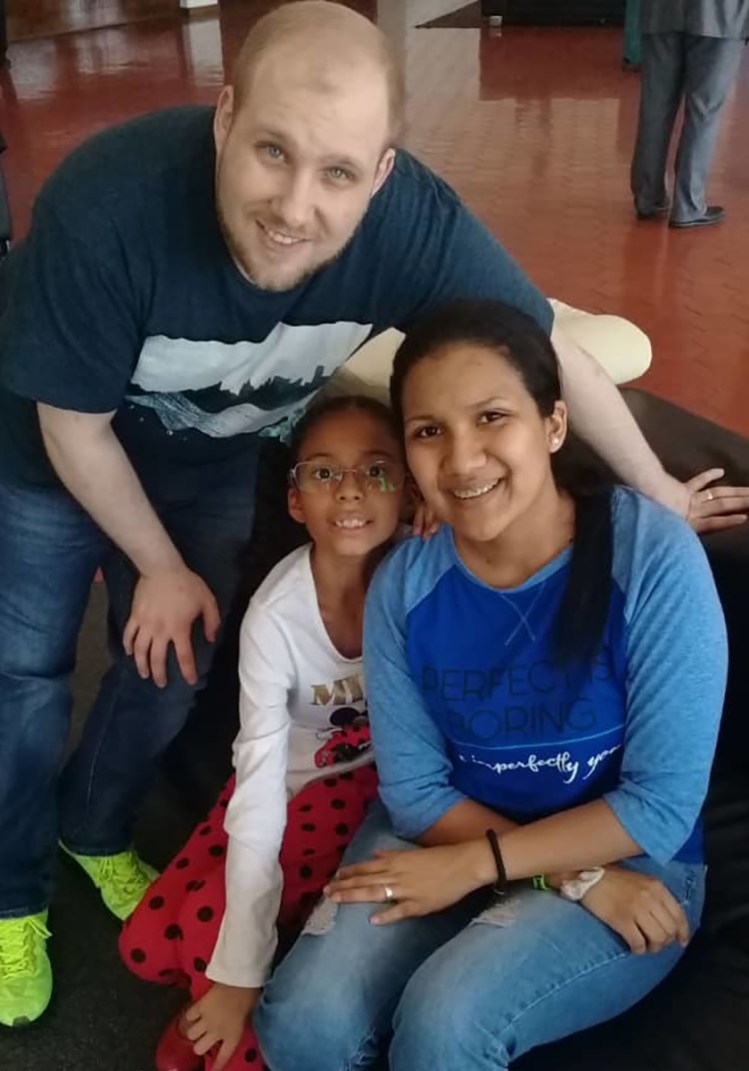 Joshua Holt poses for a photo with his wife, Thamara Caleno, and her daughter at the airport in Caracas, Venezuela, on Saturday.