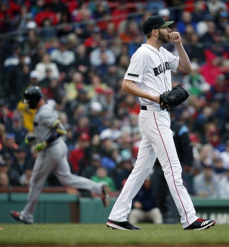 Red Sox's pitcher Chris Sale reacts after giving up a three-run home run to Atlanta's Tyler Flowers, left, in the second inning of Boston's 7-1 loss Sunday at Fenway Park.