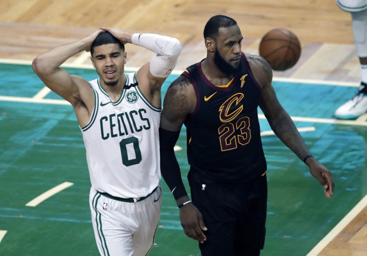 Celtics forward Jayson Tatum, left, reacts in front of Cavaliers forward LeBron James during the second half of Game 7 of the Eastern Conference finals on Sunday in Boston. Cleveland won 87-79 to reach the NBA finals.