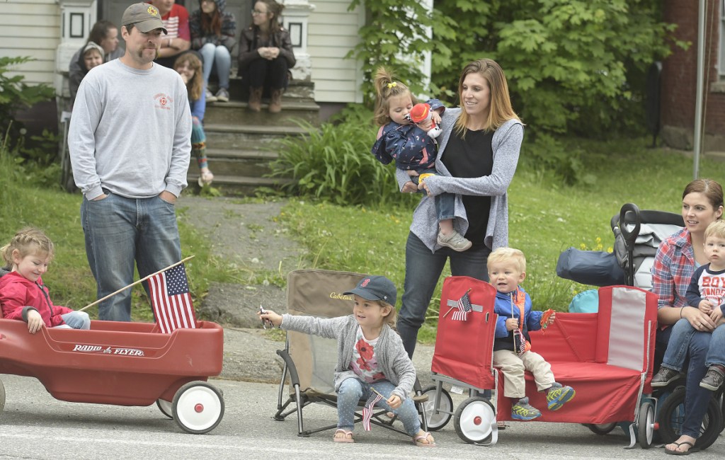 Children and their parents scramble for candy tossed into the crowd Monday during the Memorial Day parade through Gardiner.