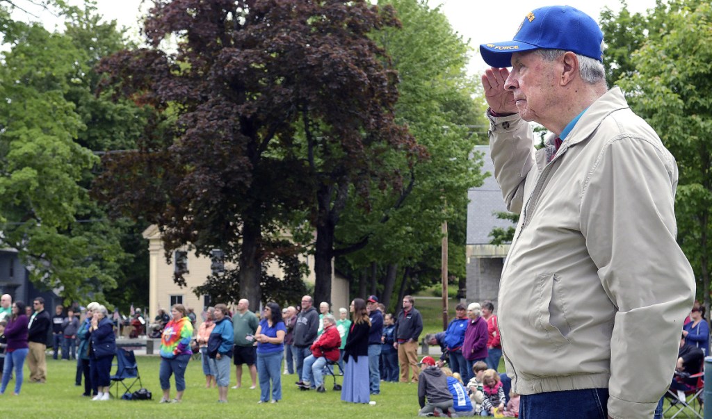 Korean War veteran Terrence Casey, 84, of Randolph, salutes the colors Monday during the Memorial Day ceremony at the Gardiner Common.