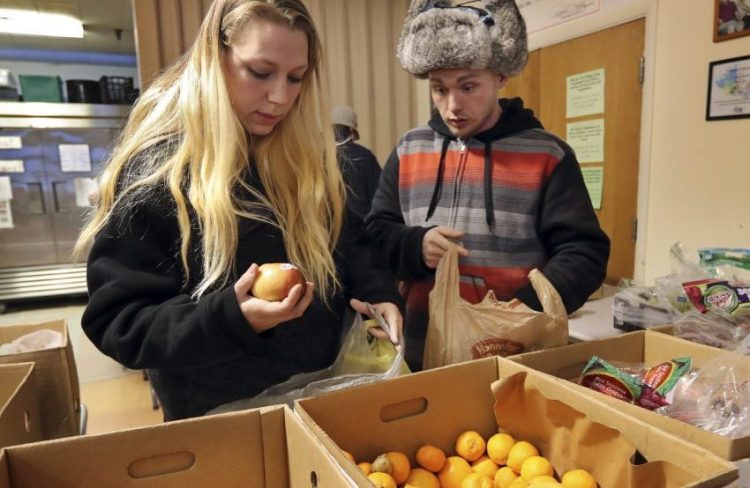 At an average of $4 a day, the federal benefits that help thousands of Mainers buy food don't last the entire month, forcing them to turn to the Augusta Food Bank, above in 2017, and other private sources of aid.