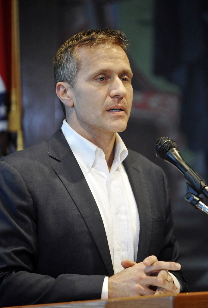 Missouri Gov. Eric Greitens reads from a prepared statement as he announces his resignation during a news conference on Tuesday.