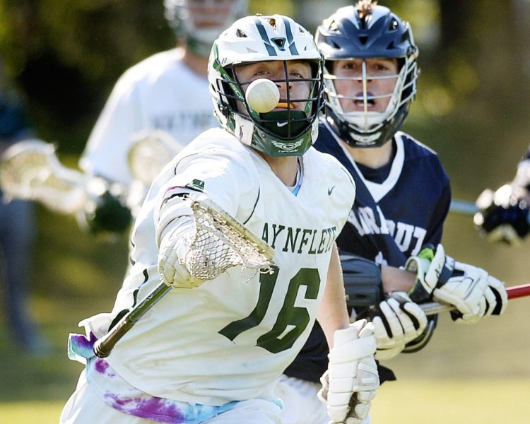 Waynflete's Hank Duvall reaches for a loose ball against Yarmouth during a 12-11 overtme victory for his Flyers on Thursday in Portland. Duvall scored four times for the Flyers.