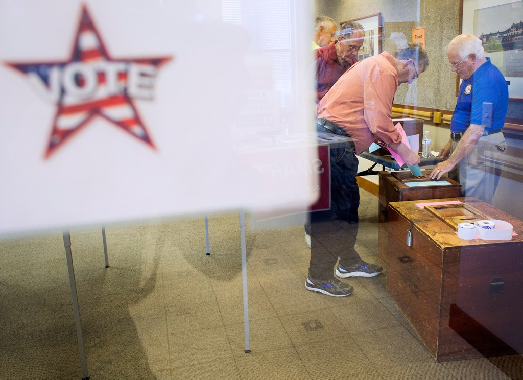 Volunteer Ralph Masciovecchio helps Roger Chabot cast his ballots in Tuesday's special recall election in Scarborough.