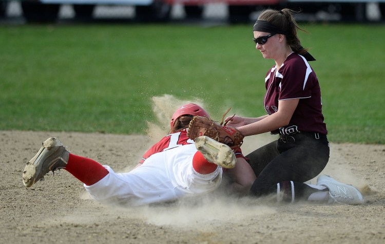 Scarborough's Sam Carreiro dives safely into second base under the tag of Noble's Lauren Sanger for a stolen base.