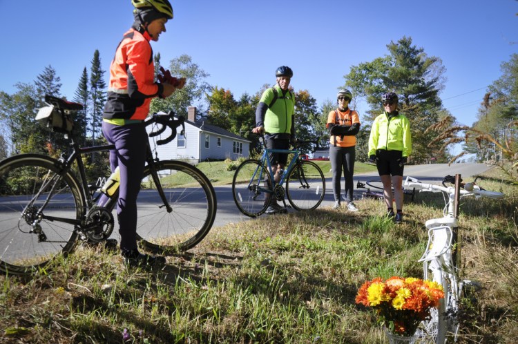 Bicycle Coalition of Maine Executive Director Nancy Grant, left, and other bicyclists pay their respects to Dr. Carol Eckert in October 2017. 