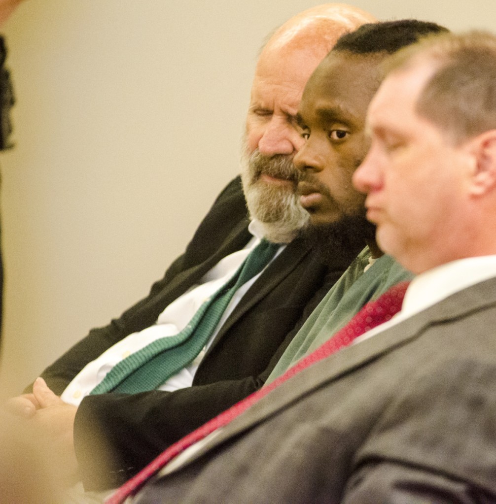 Translator John Roy, left, Aubrey Armstrong and defense attorney Brad Grant listen to the state's closing argument on Tuesday in Capital Judicial Center in Augusta. Armstrong, charged with murder, has been using an interpreter to translate between English and Guyanese Creole.