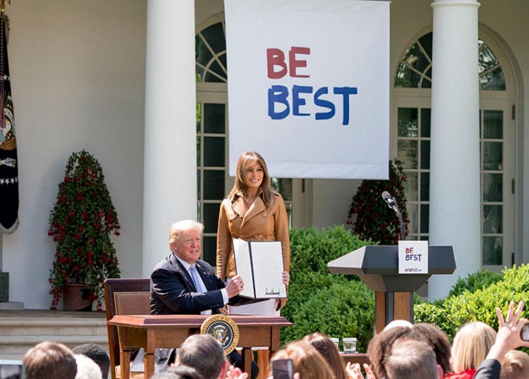 President Donald Trump and first lady Melania Trump pose together after Trump signs a proclamation during the unveiling of Melania's "Be Best" initiative on Monday.
