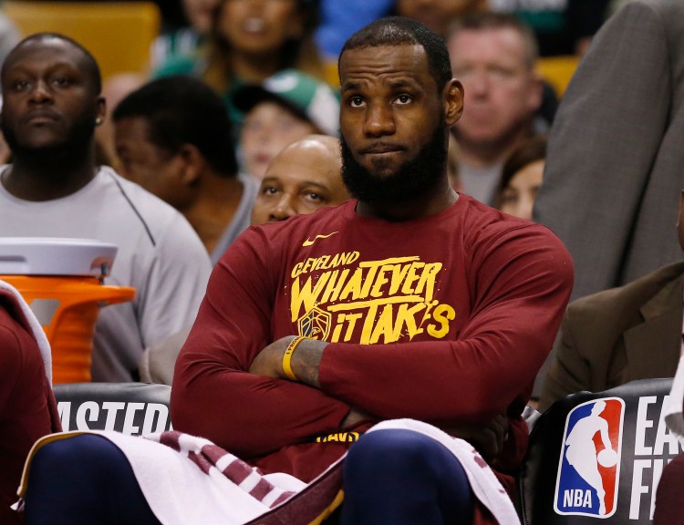 Cleveland Cavaliers forward LeBron James watches from the bench during the fourth quarter of Game 1 of the NBA basketball Eastern Conference Finals against the Boston Celtics on Sunday in Boston. 