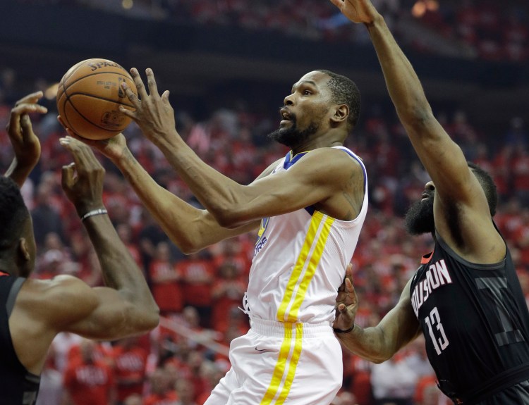 Golden State Warriors forward Kevin Durant (35) drives to the basket past Houston Rockets guard James Harden (13) during the first half of Game 1 of the NBA basketball Western Conference Finals, Monday in Houston.
