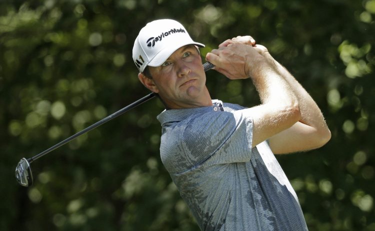  In this Aug. 20, 2016, photo, Lucas Glover plays in the Wyndham Championship golf tournament in Greensboro, N.C. 