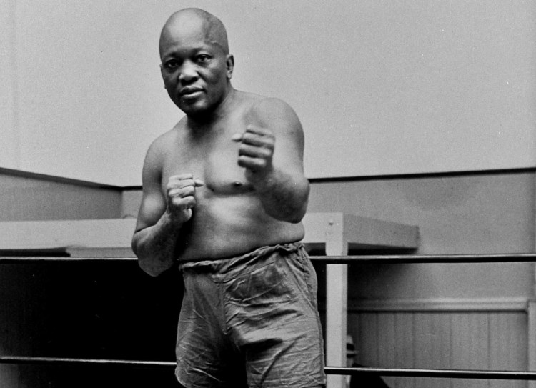 In this 1932 file photo, boxer Jack Johnson, the first black world heavyweight champion, poses in New York City. President Donald Trump on Thursday, May 24, 2018, granted a rare posthumous pardon to boxing's first black heavyweight champion, clearing Jack Johnson’s name more than 100 years after a racially-charged conviction. 