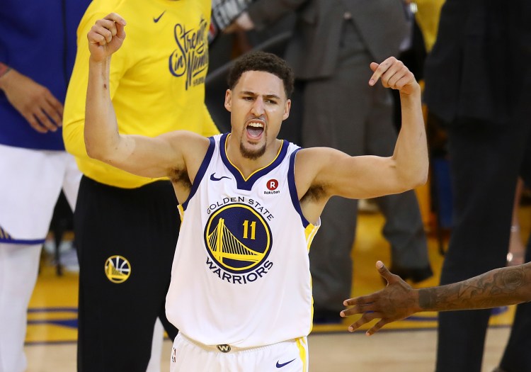Golden State Warriors guard Klay Thompson (11) celebrates during the second half of the Warriors' win in Game 6 of the Western Conference finals against the Houston Rockets on Saturday in Oakland, Calif. The Warriors won 115-86. 