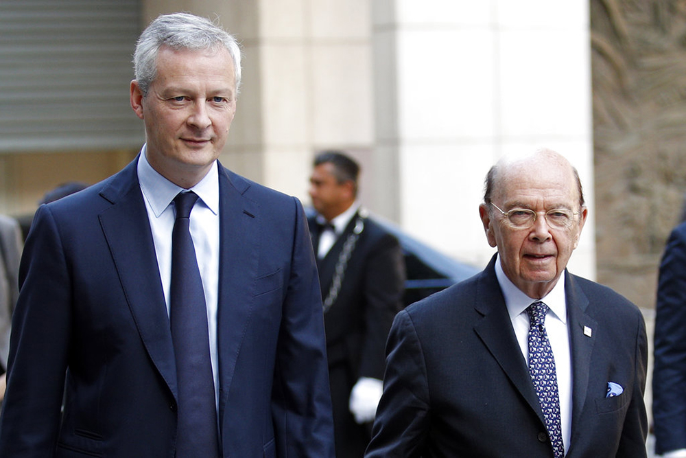 French Finance Minister Bruno Le Maire, left, welcomes U.S. Secretary of Commerce Wilbur Ross to their meeting at the French Economy Ministry in Paris on Thursday.