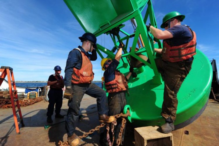 Members of Coast Guard Cutter Willow’s buoy deck crew work to install the clappers on a bell buoy before the buoy is set in the water near Block Island, R.I., in 2015. The bell in the buoy is similar to the brass items targeted by thieves.