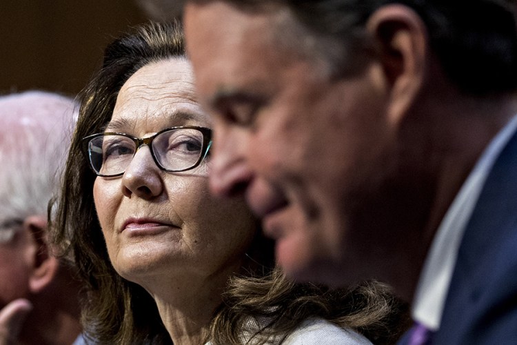 Gina Haspel, nominee to lead the  CIA, listens while being introduced by former Sen. Evan Bayh, D-Ind., right, during the Senate Intelligence Committee confirmation hearing  Wednesday. 