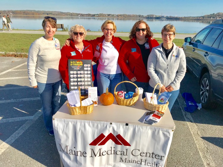 Maine Medical Center nurses, (from left) Emily Morris, R.N.; Lynne White, R.N.;  Leslie Knight, R.N.; Heidi Gwinn, R.N., and Rose Tanguay, R.N., strive to improve public health by volunteering at the 2017 National Prescription Drug Take Back Day at Back Cove in Portland.