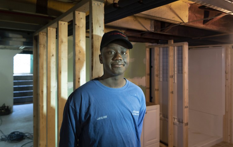 Jackson Oloya works in the basement of a home in Biddeford, where he has an internship with a plumber. Oloya came from Uganda as a young child, and has studied to be a plumber through the Biddeford Regional Center of Technology. "I enjoy putting things together, and I don't want to be working in an office," he said.