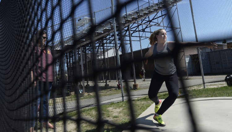 Johnna Scott of Thornton Academy, working under Coach Lisa Huntress, and her teammate Jaigan Boudreau are the two top discus throwers in the state.