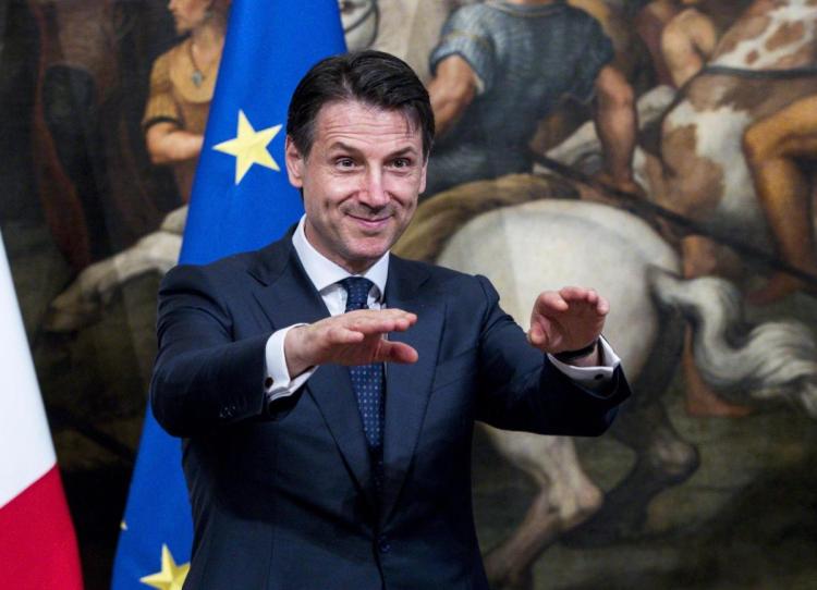 Italy's new premier, Giuseppe Conte, gestures during the handover ceremony at Chigi Palace in Rome on Friday.