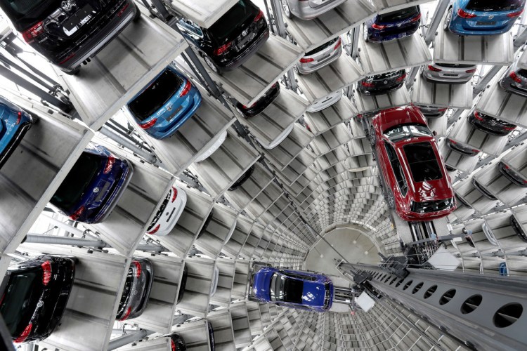 Volkswagen cars are lifted inside a delivery tower of the company in Wolfsburg, Germany. Germany's Volkswagen, Europe's largest automaker, is warning that the Trump administration's decision to impose tariffs on aluminum and steel imports from Canada, Mexico, and the European Union could start a trade war that no side would win.