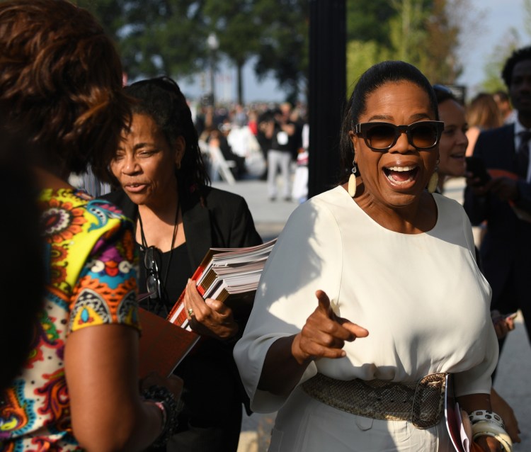 Oprah Winfrey waves to fans as she arrives for the opening of the National Museum of African American History and Culture in 2016.