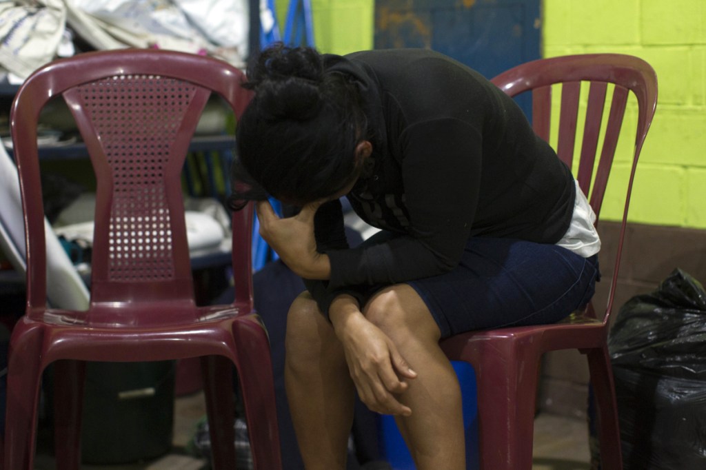 Fidelina Lopez cries for her missing relatives at a shelter in Alotenango, Guatemala. One of Central America's most active volcanos erupted in fiery explosions of ash and molten rock Sunday, killing at least 25 people and injuring multiple others while a towering cloud of smoke blanketed nearby villages in heavy ash.