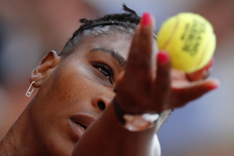 Serena Williams serves against Germany's Julia Georges during their third-round match of the French Open at Roland Garros stadium in Paris, France on Saturday. Williams had to withdraw from the tournament with an injured pectoral muscle.