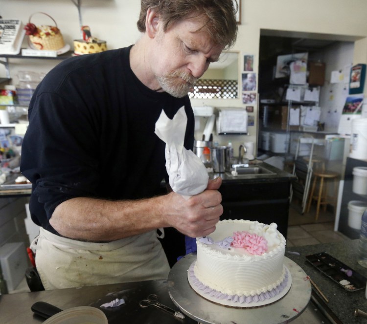 Masterpiece Cakeshop owner Jack Phillips decorates a cake inside his store in Lakewood, Colo. The Supreme Court set aside a Colorado court ruling against the baker, who wouldn't make a wedding cake for a same-sex couple. But the court is not deciding the big issue in the case, whether a business can refuse to serve gay and lesbian people.