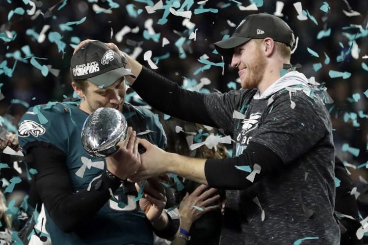 Philadelphia Eagles quarterback Carson Wentz, right, celebrates with Nick Foles after winning the Super Bowl in Minneapolis in February. President Trump has called off a visit by the Eagles to the White House, initially saying the team disagreed with him about the need to stand during the national anthem. It turns out that none of the Eagles champions had taken a knee during the anthem in 2017.
