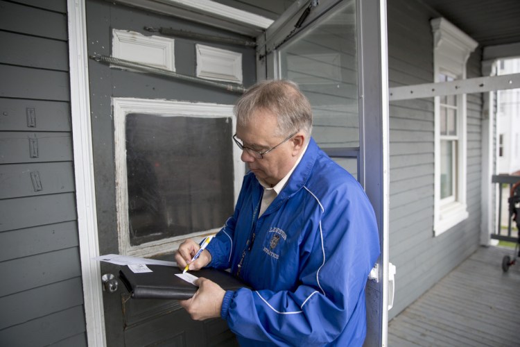 Butch Pratt, longtime truancy officer for the Lewiston school district, writes down his number and a note to leave on the door of an apartment where he hoped to discuss a student's absenteeism. Sixteen percent of Maine students – more than 29,000 – miss more than 10 percent of the school year, new state statistics show.