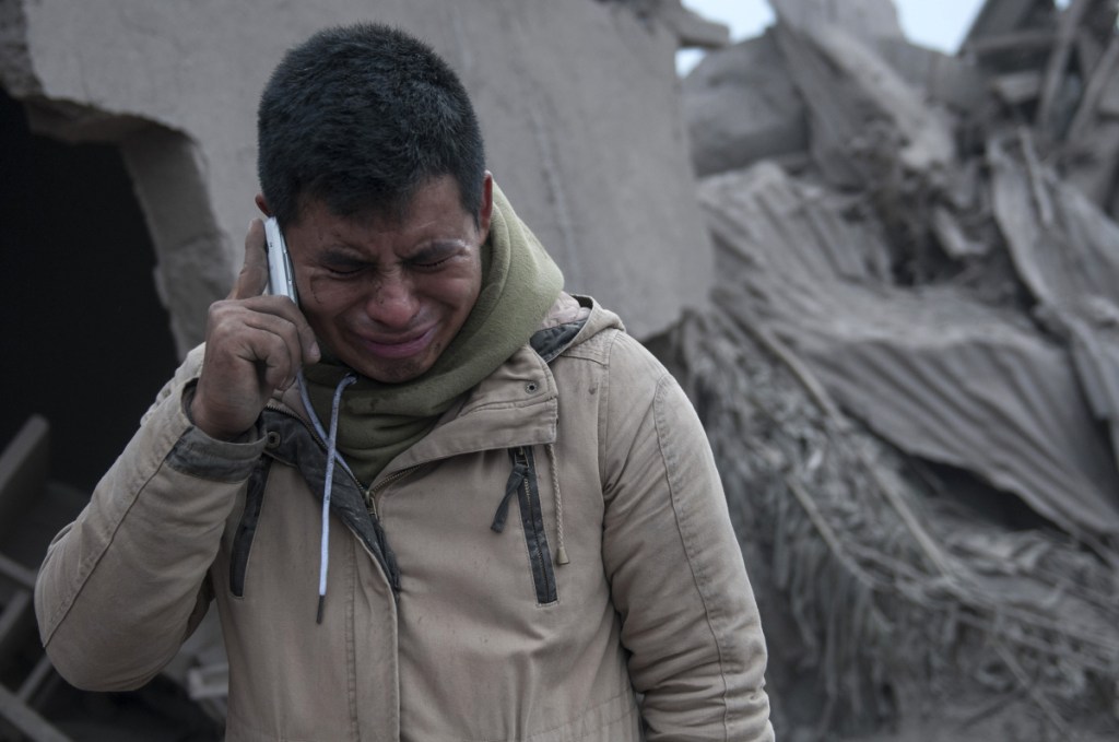 Boris Rodriguez, 24, who is searching for his wife, cries after seeing the condition of his neighborhood, destroyed by the super-heated muck.