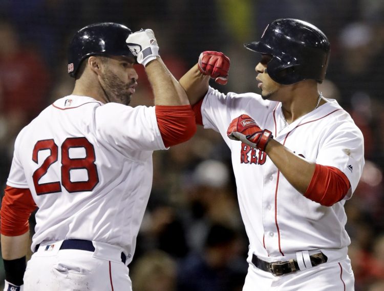 Boston's Xander Bogaerts, right, is congratulated by J.D. Martinez after his solo home run against Detroit during the fifth inning of Tuesday's game at Fenway Park in Boston.