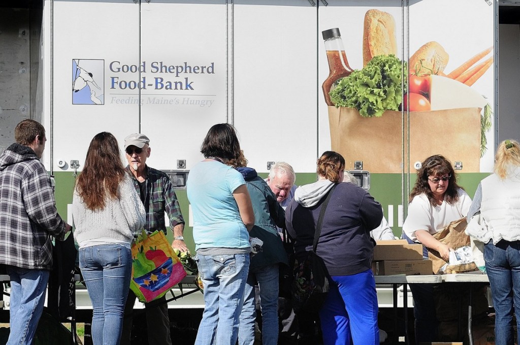 Volunteers distribute food from a Good Shepherd mobile food bank in 2013 in Augusta. A letter writer points out that one in six people goes to bed hungry in Maine.